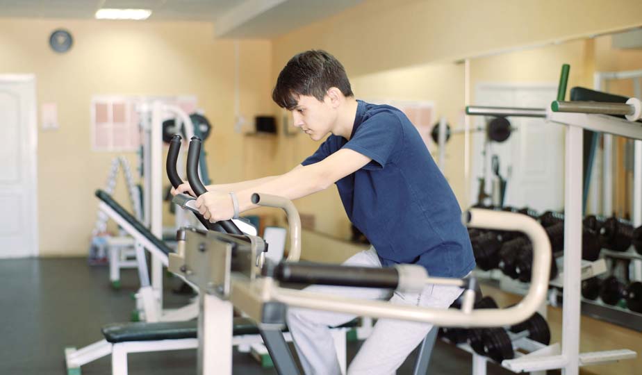 This is an image of a Man exercising in Gym, According to a Study exercising can prevent hearing loss.
